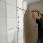 Drilling through a wall at HMO on Ashley Road