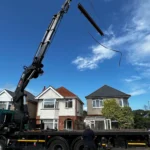 Steel beam being lifted by a crane for an extnesion in Bournemouth